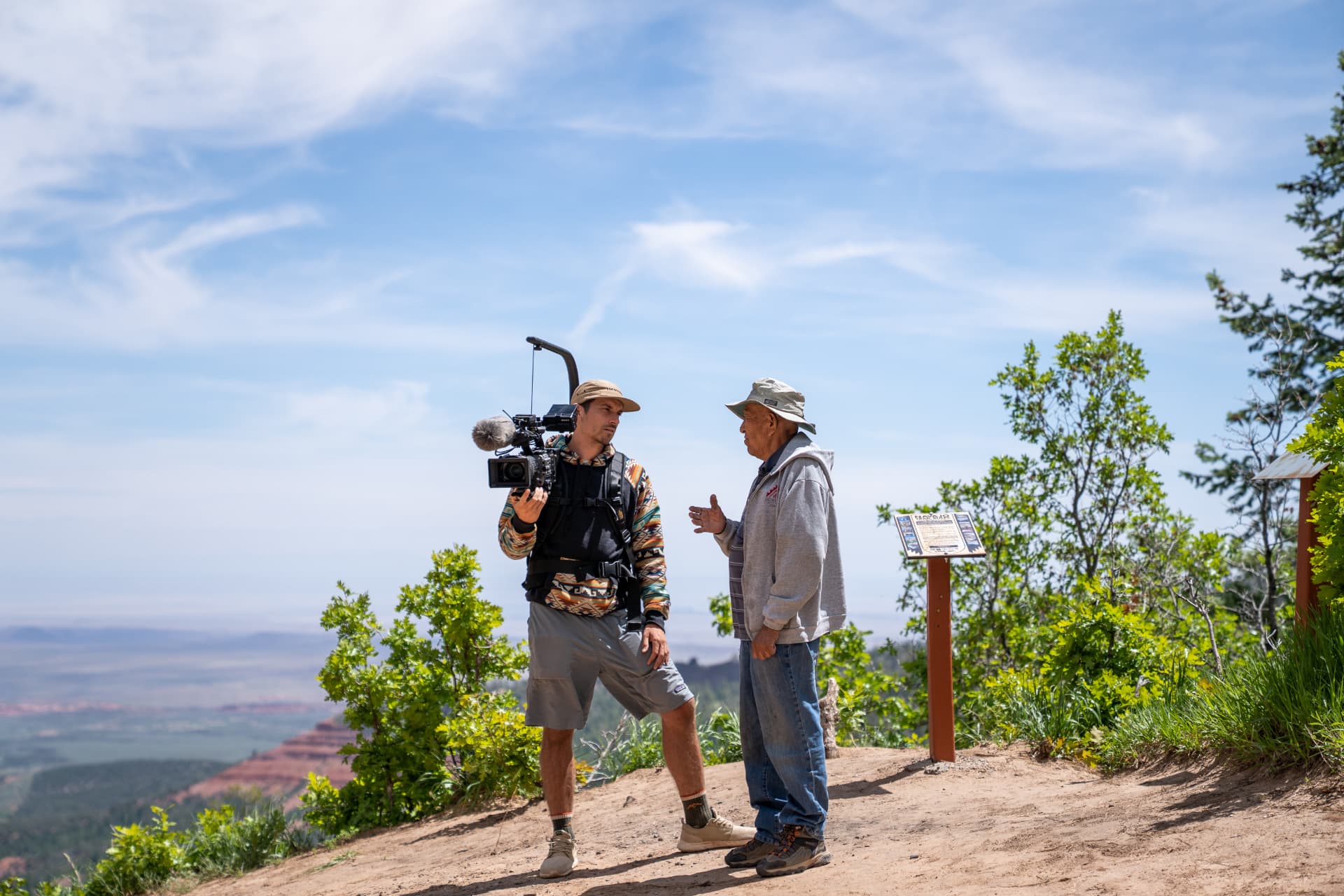 Cedar Wood filming with a Navajo elder on an overlook above Bluff, Utah